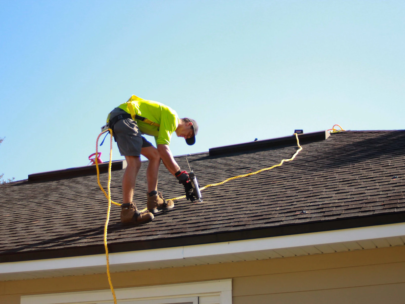 Roofing professional working on a residential roof during a roof evaluation